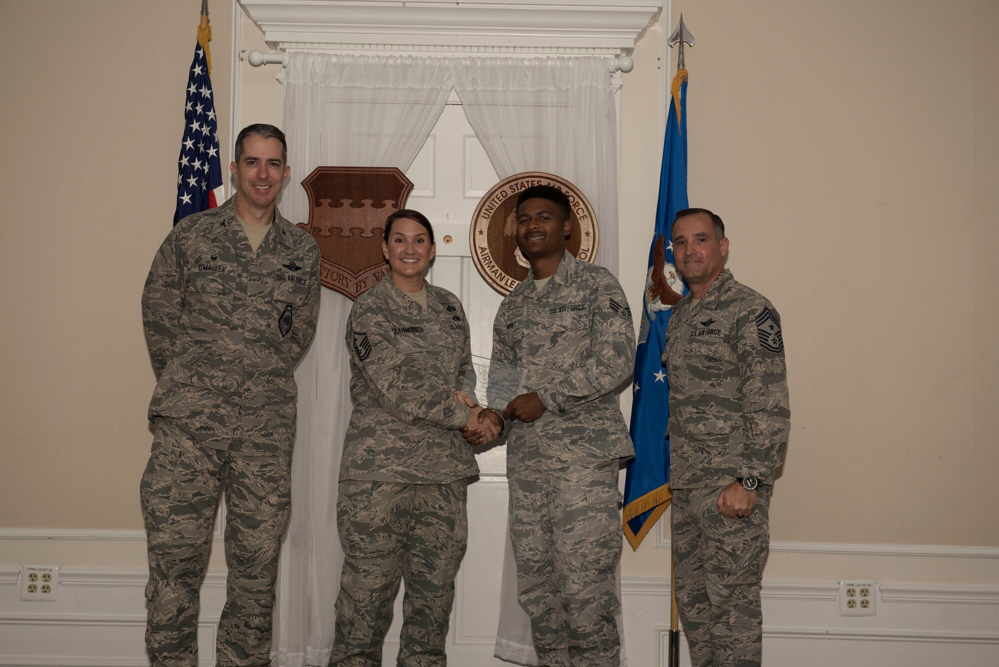 U.S. Air Force Senior Airman Avery Mooney, Airman Leadership School (ALS) student assigned to the 50th Attack Squadron, receives a distinguished graduate award for Class 18-6 of the Senior Master Sgt. David B. Reid ALS, at Shaw Air Force Base, S.C., Aug. 23, 2018.