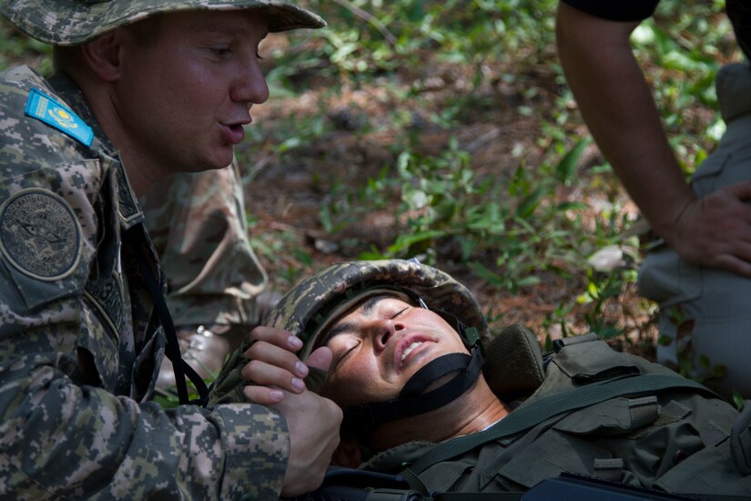 A medic from the Armed Forces of Kazakhstan, tends to a comrade wounded by insurgent sniper fire as part of a scenario during the Field Training Exercise portion of Exercise STEPPE EAGLE 18. 

Military-to-military exercises have served as an excellent training opportunity to strengthen tactical proficiency and support regional stability.