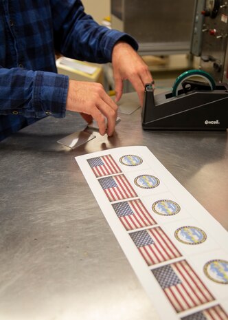 A fresh print out to create ID tags is ready for processing. (Photo by Robin L. Lee, PSNS & IMF photographer)