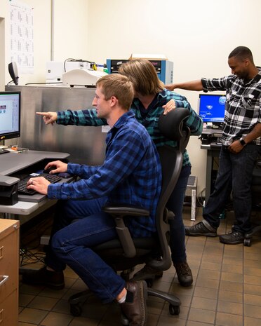 Members of the Puget Sound Naval Shipyard & Intermediate Maintenance Facility’s Sheet Metal Shop Jordan Veach, Kris Holmberg and Sean Joyner use the new photo sensitive label plate process to create ID tags. (Photo by Robin L. Lee, PSNS & IMF photographer)