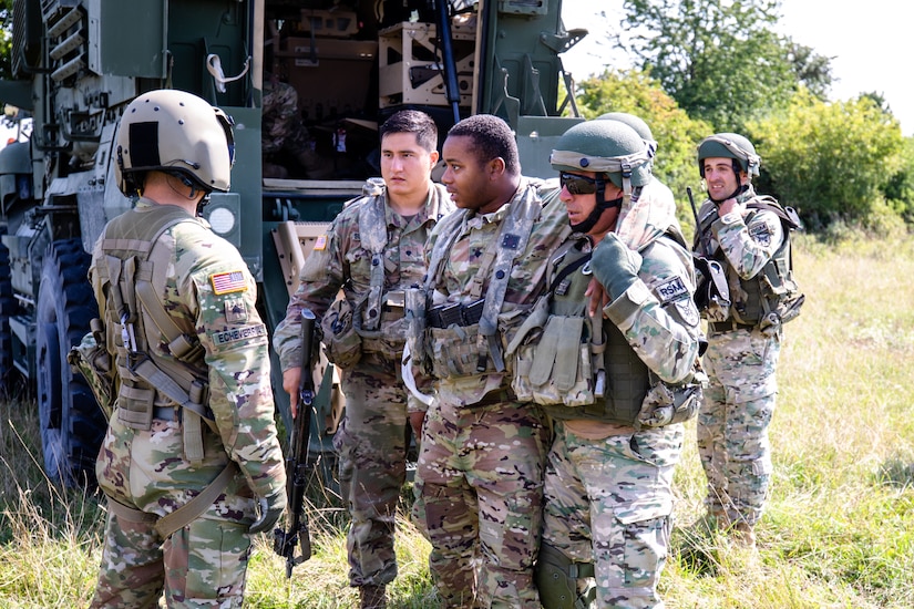 Army Sgt. Rodolfo Echeverria, left, a flight medic with Charlie Company, 2nd General Support Aviation Battalion, directs U.S. and Georgian soldiers during a medical evacuation training exercise at Hohenfels Training Area, Germany, Aug. 21, 2018. Army photo by Pfc. Matthew J. Marcellus