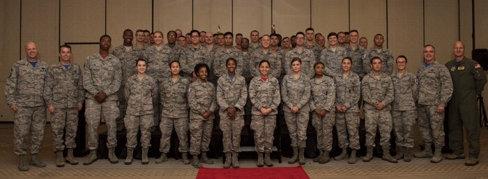 Joint Base Charleston's newest staff sergeant selects from the 628th Air Base Wing stand on stage to be recognized during the Staff Sergeant Release Party Aug. 24, 2018, at the Charleston Club.
