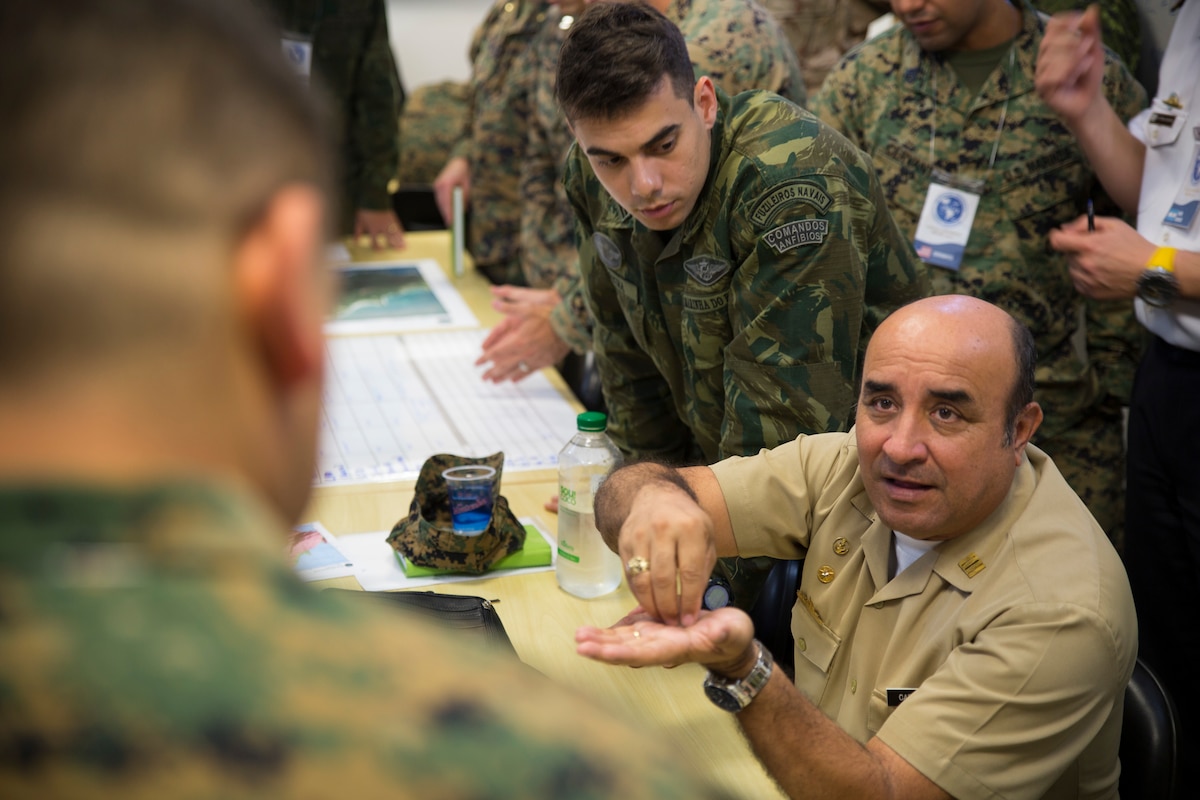 An Ecuador Navy Captain talks to a U.S. Marine