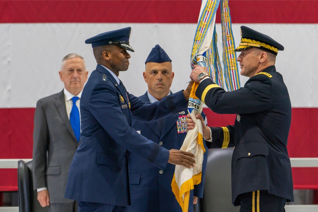 The commander of U.S. Transportation Command hands a guidon to the new commander.