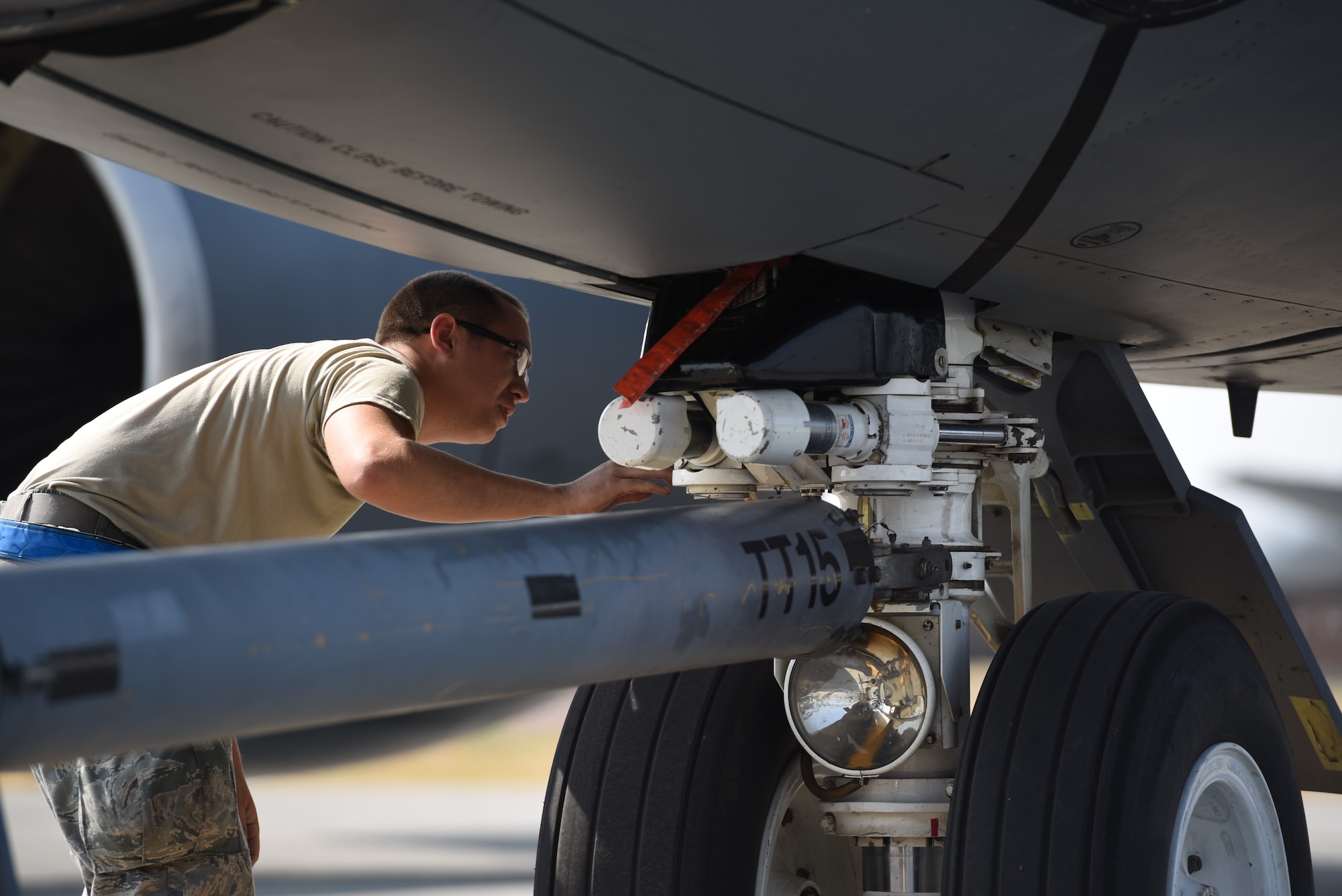 Senior Airman Tyler Turoczy, 92nd Maintenance Squadron crew chief, checks the axle of a KC-135 Stratotanker assigned to the 92nd Air Refueling Wing, Aug. 22, 2018, at Fairchild Air Force Base, Washington. Titan Fury is a readiness exercise used to validate and enhance Fairchild Airmen’s ability to provide Rapid Global Mobility as required by the U.S. Strategic Command and U.S. Transportation Command. (U.S. Air Force photo by Airman 1st Class Lawrence Sena)