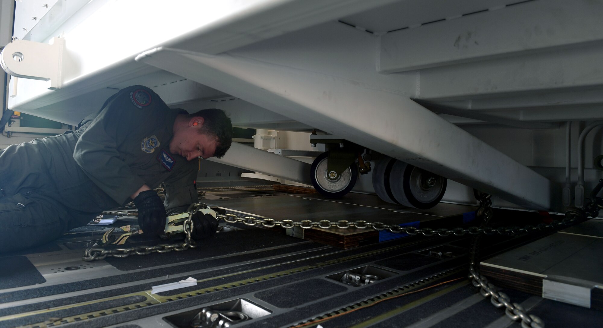 Airman 1st Class Alexander Herman, a loadmaster assigned to the 4th Airlift Squadron, secures the very first GPS III satellite, SV-01, affectionately dubbed “Vespucci” in honor of Amerigo Vespucci, the Italian explorer for whom the Americas were named, onto a C-17 Globemaster III in preparation for takeoff from Buckley Air Force Base, Colorado, Aug. 20, 2018.