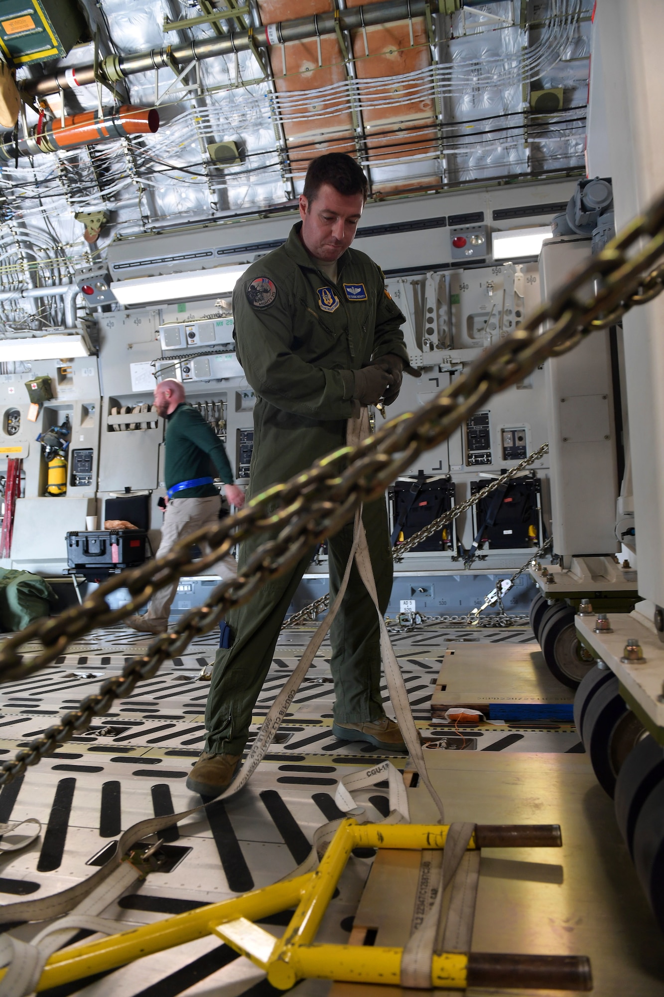 Tech. Sgt. Eugene Mehaffy, Jr., a loadmaster assigned to the 313th Airlift Squadron, secures the very first GPS III satellite, SV-01, named “Vespucci” in honor of Amerigo Vespucci, the Italian explorer for whom the Americas were named, onto a C-17 Globemaster III in preparation for takeoff from Buckley Air Force Base, Colorado, Aug. 20, 2018.