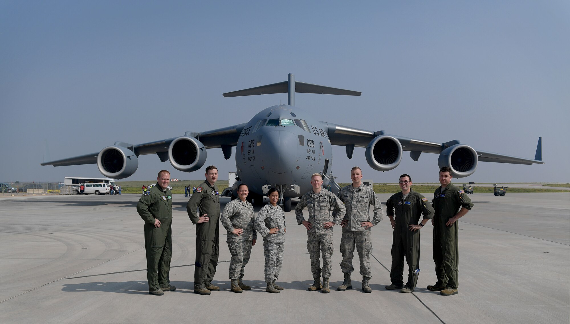 Airmen involved in the loading of the very first GPS III satellite gather for a group photo in front of a C-17 Globemaster III prior to its takeoff from Buckley Air Force Base, Colorado, Aug. 20, 2018.