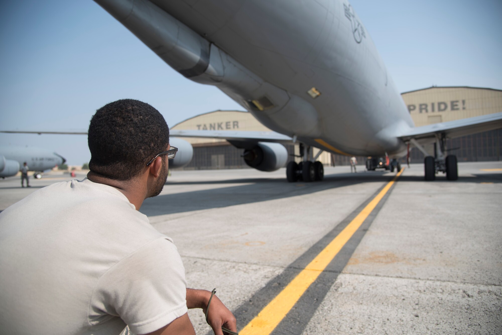 Airman 1st Class Myles Jackson, 92nd Maintenance Squadron crew chief, helps line up a parking space for a KC-135 Stratotanker assigned to the 92nd Air Refueling Wing, Aug. 22, 2018, at Fairchild Air Force Base, Washington. Titan Fury is a readiness exercise used to validate and enhance Fairchild Airmen’s ability to provide Rapid Global Mobility as required by U.S. Strategic Command and U.S. Transportation Command. (U.S. Air Force photo/ Senior Airman Ryan Lackey)