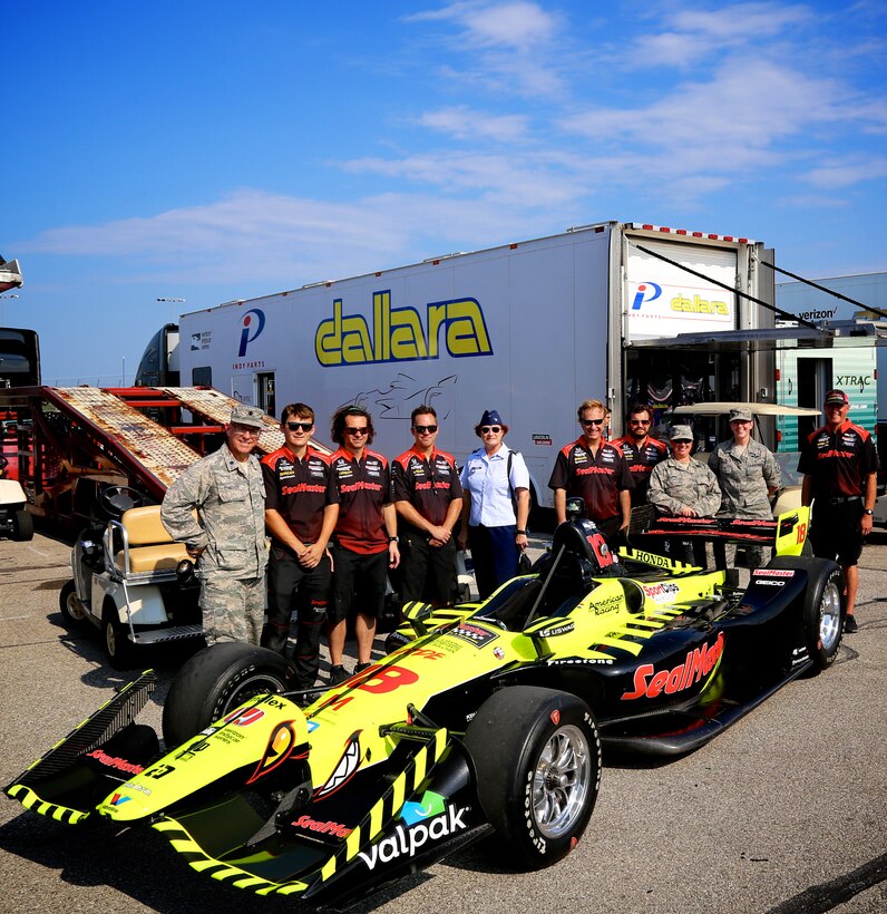 The Air Force Reserve was represented at a recent Indy car race.  As part of the pre-event backstage program, members of the 932nd Airlift Wing met some teams of Indy cars on "pit row" as they prepped engines and tires at the Gateway track.  At center in blue uniform, 932nd Airlift Wing Maintenance Group commander, Col. Sharon Johnson, meets the crew of #18, the car driven by Sebastian Bourdais.  She was recognized on stage with all the Indy drivers at the Bommarito Automotive Group 500 race Aug. 25, 2018, Gateway Motorsports Park, Madison, Illinois. Johnson was an honored VIP to help kick off the second annual IndyCar race which was won by Will Power, who actually came in last place the year prior.  This year he won the 248-lap race around the four-turn, 1.25-mile Gateway Motorsports Park paved track in Madison, Illinois, in his #12 Chevrolet car by 1.3117 seconds over second place finisher Alexander Rossi.  The 932nd Airlift Wing was represented by maintenance, medical, public affairs staff and operations personnel.  (U.S. Air Force photo by Lt. Col. Stan Paregien