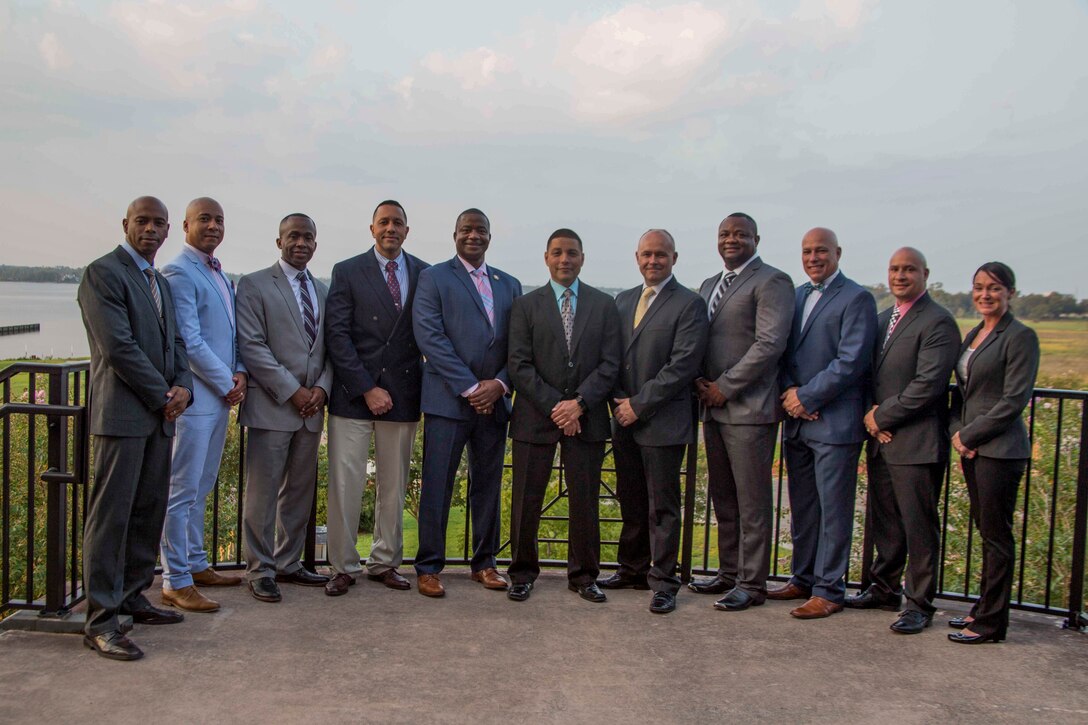 All recruiting instructors attending the 8412 Symposium professional dinner gather for a group photo at Keesler Air Force Base, Mississippi, Aug. 23, 2018. The symposium brought all 6th MCD career recruiters, sergeants major and commanding officers together to provide information, develop updated recruiting products, and conduct sustainment training for the professional development of the recruiting force. (U.S. Marine Corps photo by Cpl. Jorge A. Rosales)