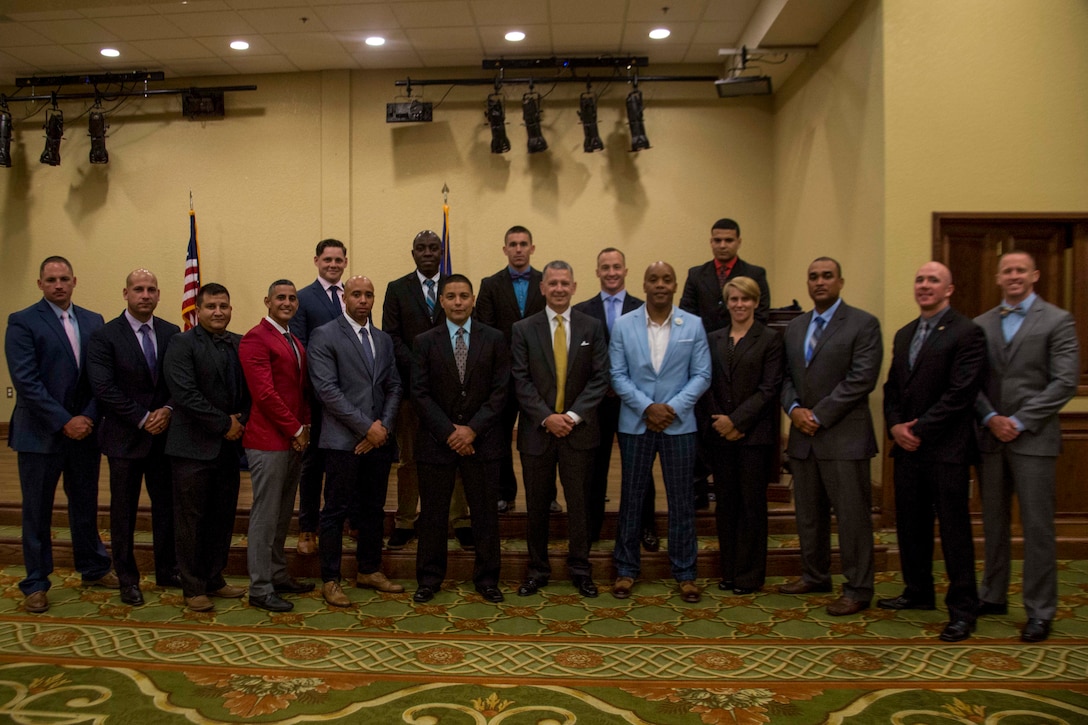 Col. William C. Gray, 6th Marine Corps District’s commanding officer and Sgt. Maj. Cortez L. Brown, 6th MCD’s sergeant major, recognize Marines aspiring to become career recruiters at a professional dinner during the 8412 Symposium at Keesler Air Force Base, Mississippi, Aug. 23, 2018. Coming the new fiscal year, RS Nashville will transition from 6th MCD to 4th MCD. The symposium brought all 6th MCD career recruiters, sergeants major and commanding officers together to provide information, develop updated recruiting products, and conduct sustainment training for the professional development of the recruiting force. (U.S. Marine Corps photo by Cpl. Jorge A. Rosales)