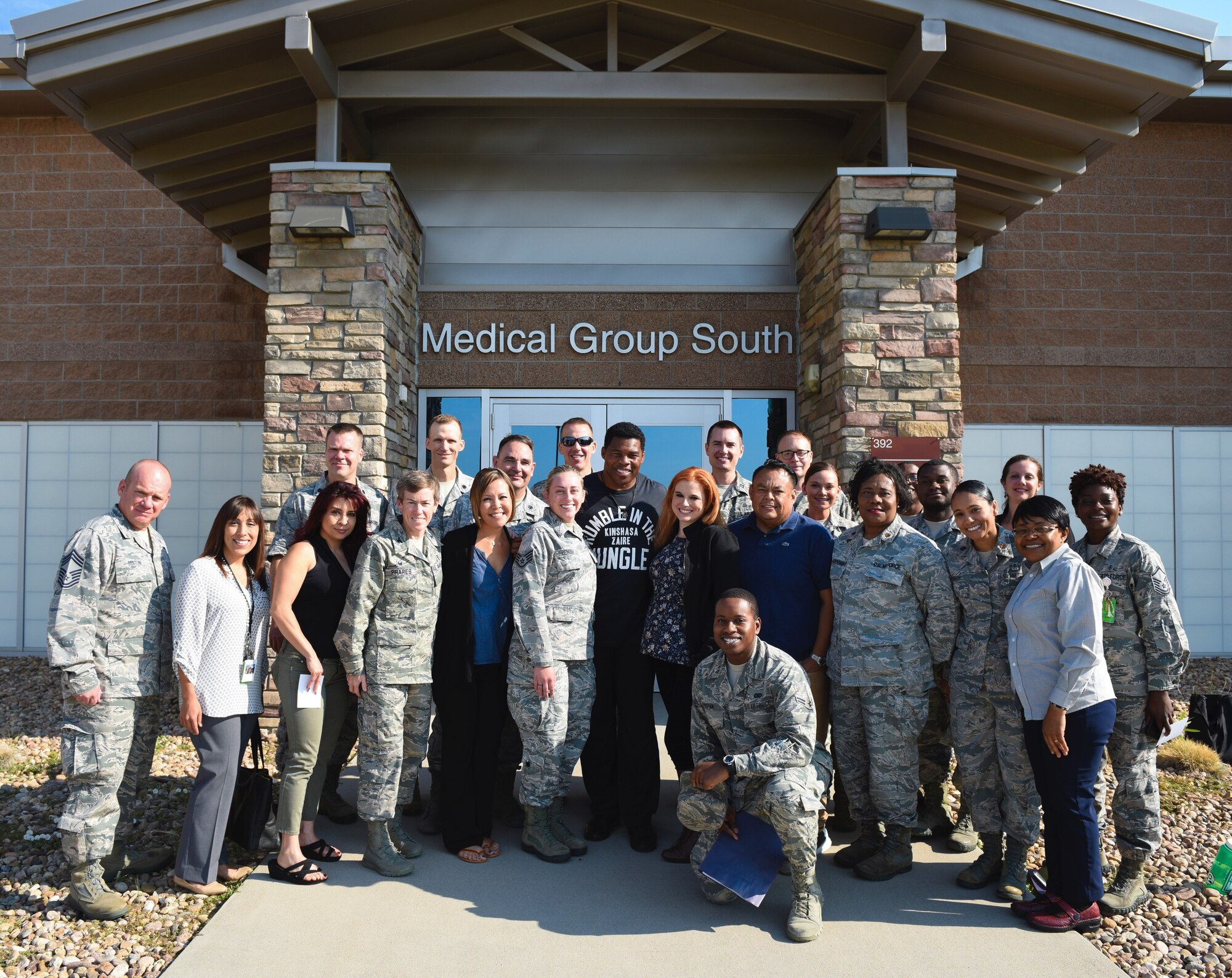 Herschel Walker, college football hall-of-fame star, joins the 460th Medical Group for a group photo Aug. 15, 2018, on Buckley Air Force Base, Colorado. Walker visited Buckley AFB to share his story and experience with mental illness and to let Airmen know it is okay to seek help. (U.S. Air Force photo by Airman 1st Class Michael D. Mathews)