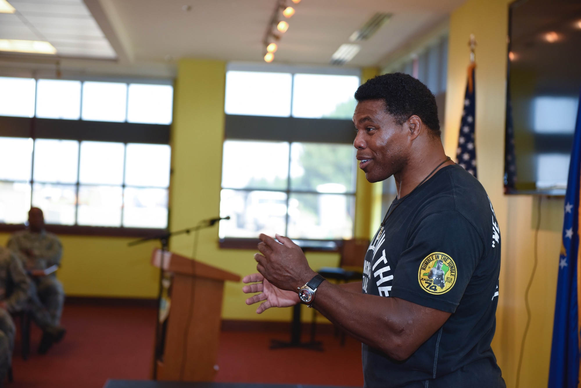 Herschel Walker, college football hall-of-fame star, speaks with Team Buckley Airmen Aug. 15, 2018, on Buckley Air Force Base, Colorado. Walker has visited over 300 bases to discuss his personal experiences to help service-members battle mental illness. (U.S. Air Force photo by Airman 1st Class Michael D. Mathews)
