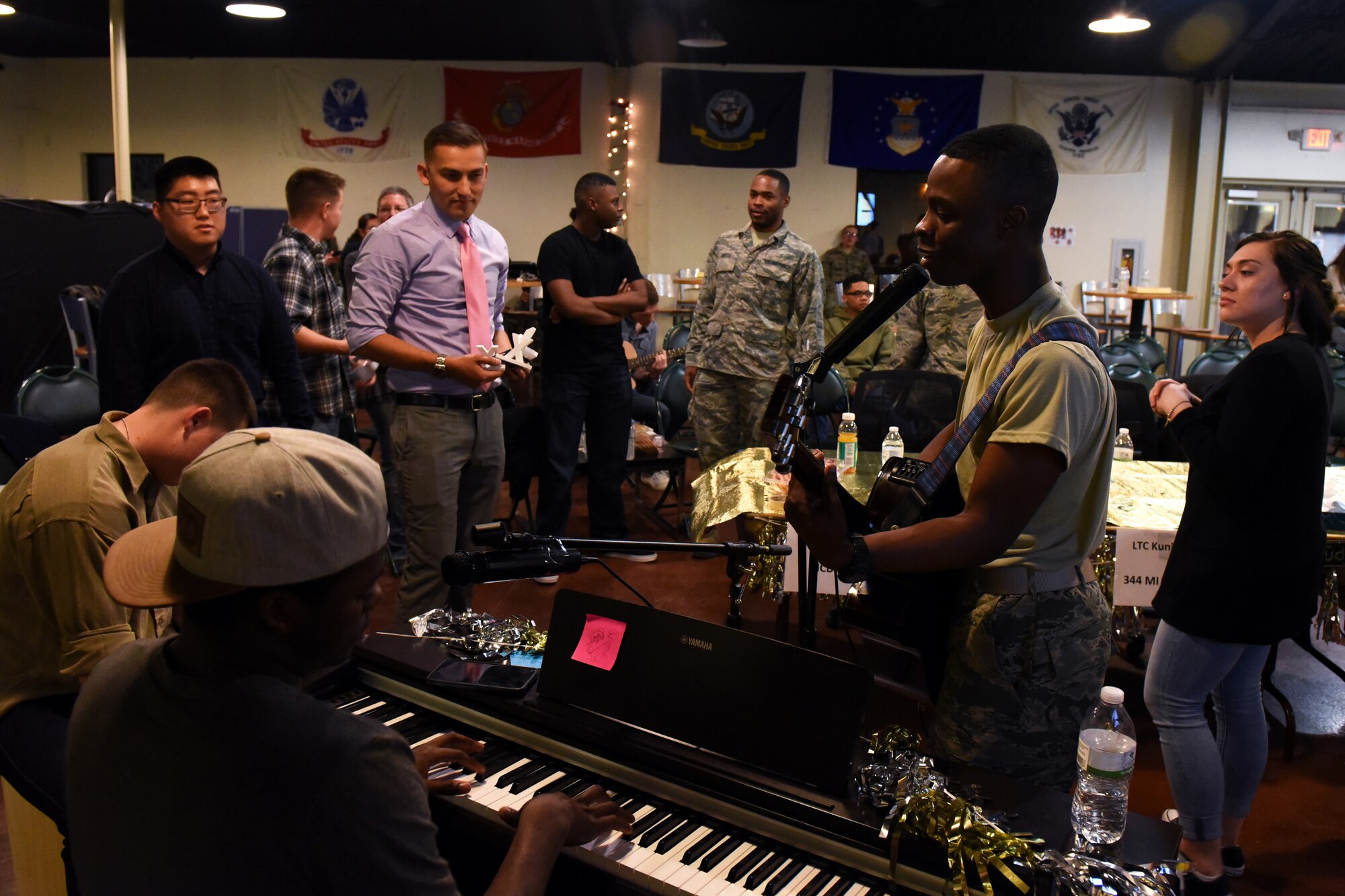 Members of Goodfellow Air Force Base play music together on a break during a talent show at the Crossroads on Goodfellow AFB, Texas, Feb. 16, 2018. Talent shows are just one of the many events for members to come together. (U.S. Air Force photo by Airman 1st Class Zachary Chapman/Released)