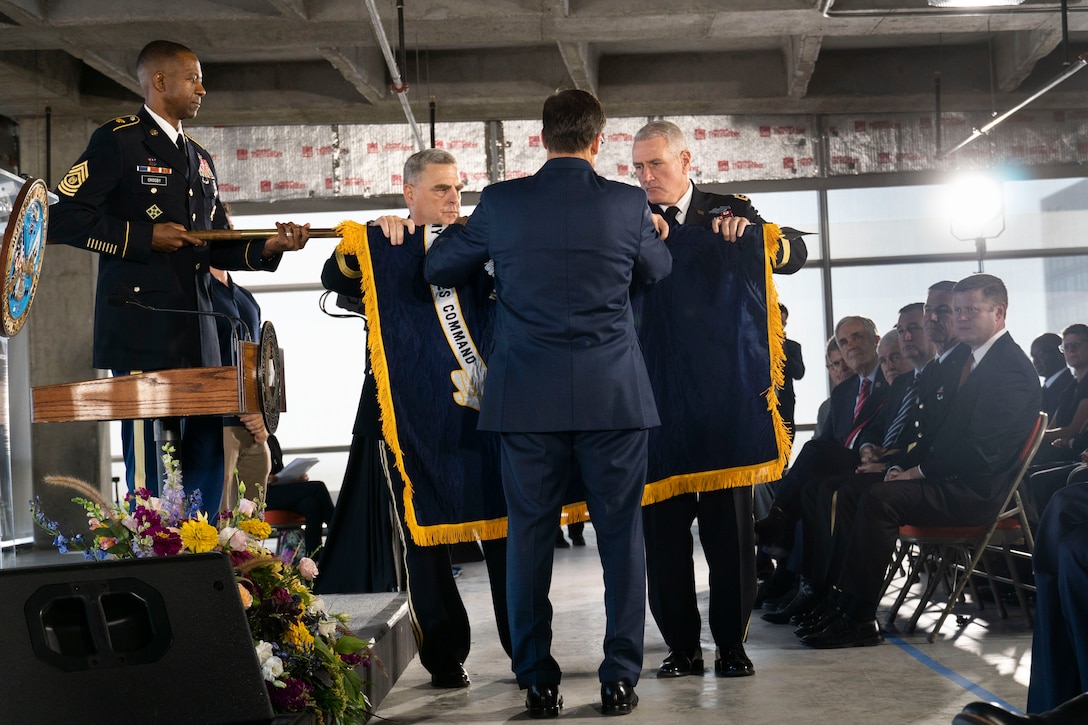 Army Command Sgt. Maj. Michael A. Crosby, left, nominated as command sergeant major for U.S. Army Futures Command, holds the U.S. Futures Command's colors as, left to right, Gen. Mark A. Milley, Chief of Staff of the Army, the Honorable Mark T. Esper, Secretary of the Army, Gen. John M. Murray, Commanding General of the U.S. Army Futures Command, unfurl the newly established command's colors during the activation ceremony in Austin, Texas.