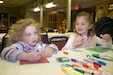 Sadie Mai, 3, left, and her sister Savannah Mai, 4, daughters of a 1st Theater Sustainment Command Soldier, make cards Nov. 15 during a 1st TSC Family Readiness Group meeting at Veterans of Foreign Wars Post 10281 in Vine Grove, Ky. The cards will be included in care packages that will be sent to First Team members who are deployed to Southwest Asia. (US Army photo by Master Sgt. Jonathan Wiley)