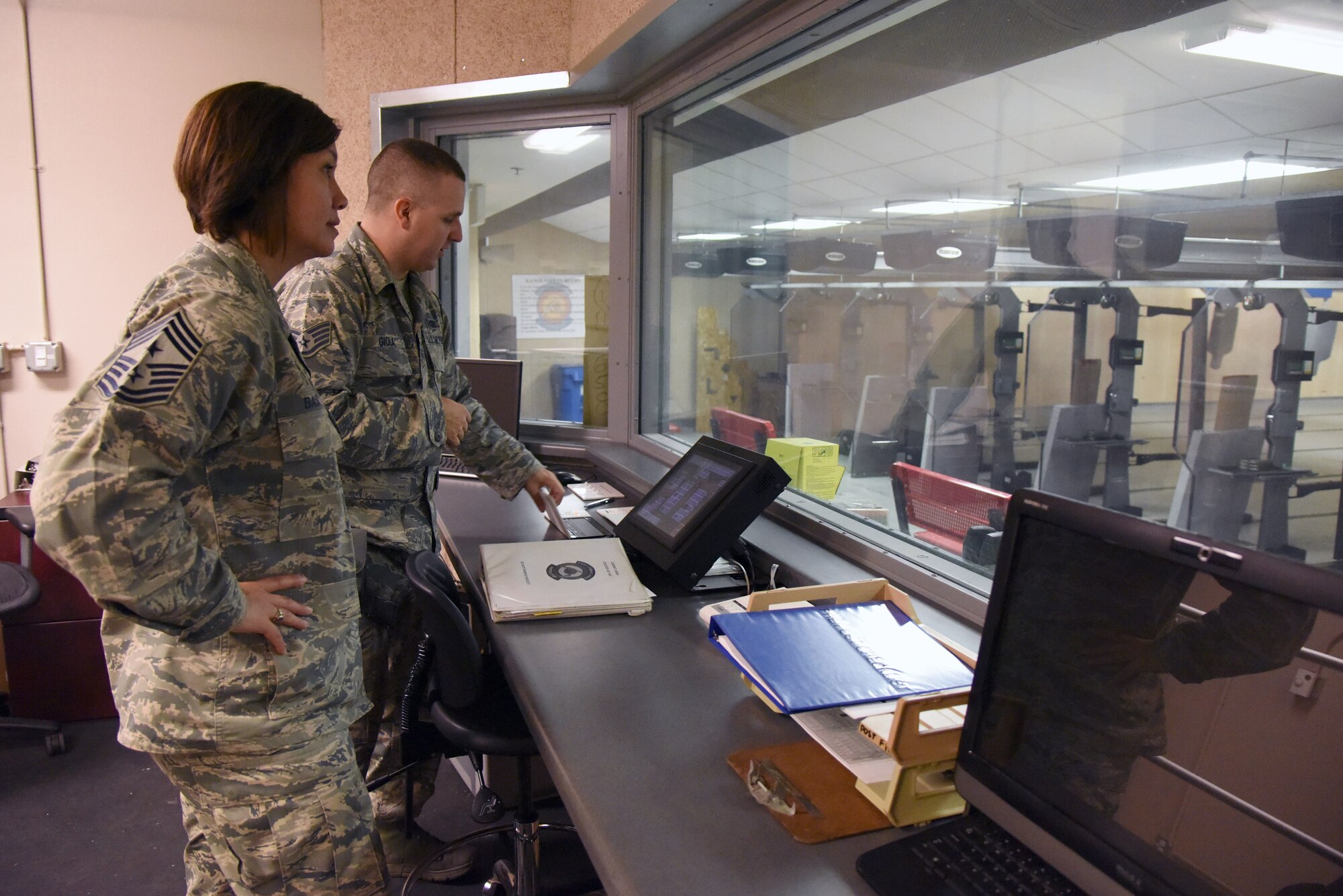 Staff Sgt. Derek Gioia, 81st Security Forces Squadron combat arms instructor, demonstrates the capabilities of the 81st SFS indoor firing range for Chief Master Sgt. JoAnne Bass, 2nd Air Force command chief, during an immersion tour on Keesler Air Force Base, Mississippi, Aug. 23, 2018. Bass's one-day tour also included the Keesler Medical Center, 81st Training Group and Wing Staff Agency. (U.S. Air Force photo by Kemberly Groue)