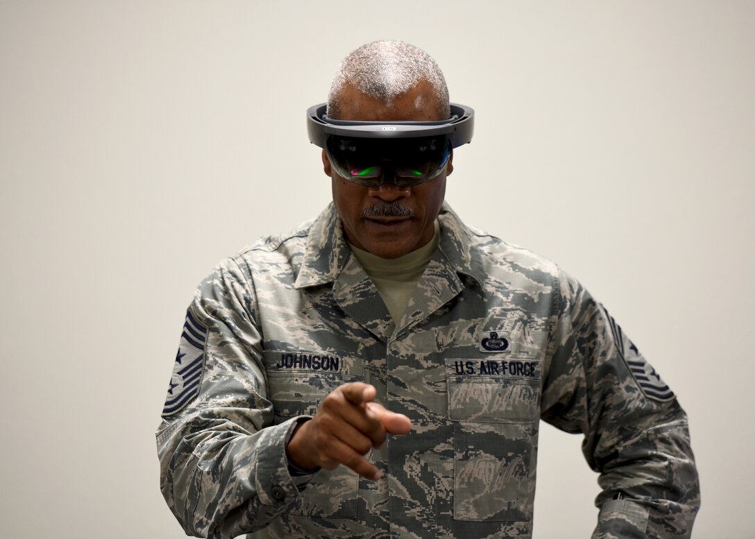 CMSgt. Jack Johnson looks as if he is pointing at you but is actually interacting with a virtual engine that only he can see.