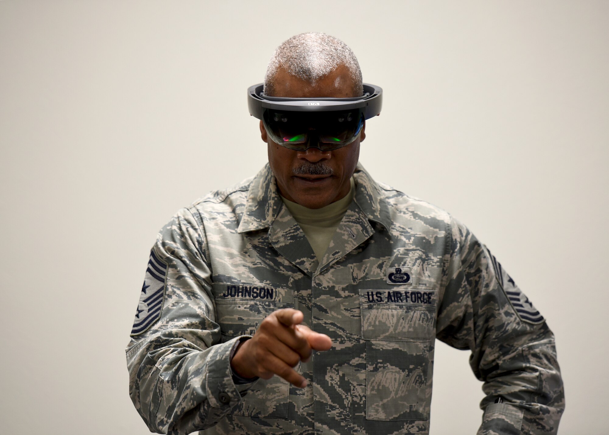 CMSgt. Jack Johnson looks as if he is pointing at you but is actually interacting with a virtual engine that only he can see.