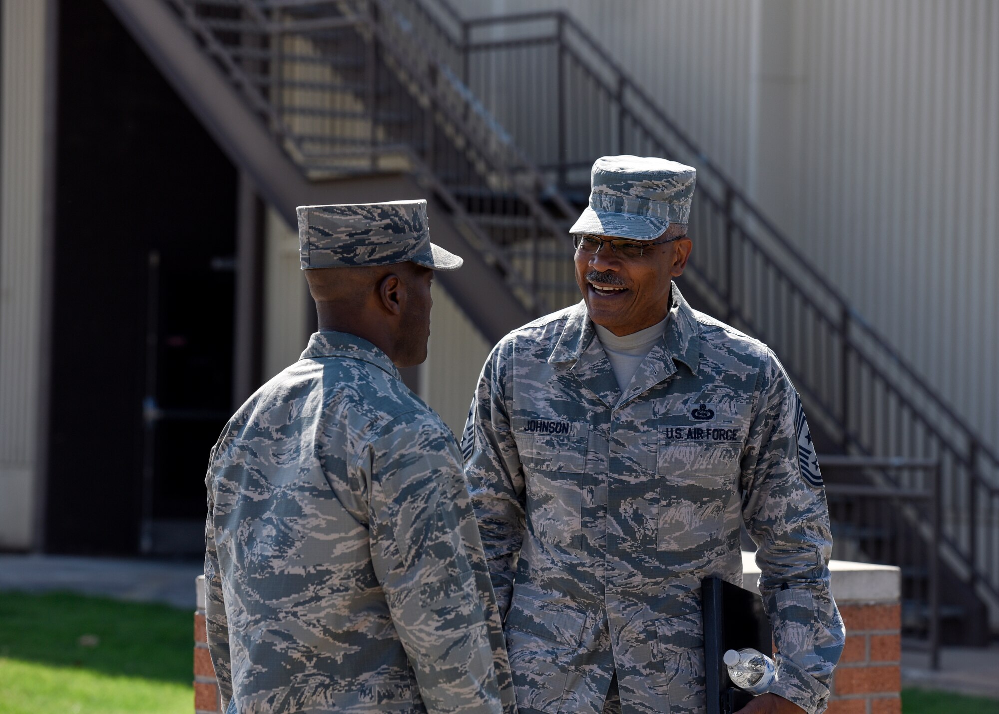 Brig. Gen. Ronald Jolly welcomes CMSgt. Jack Johnson in front of the Airman Leadership School.