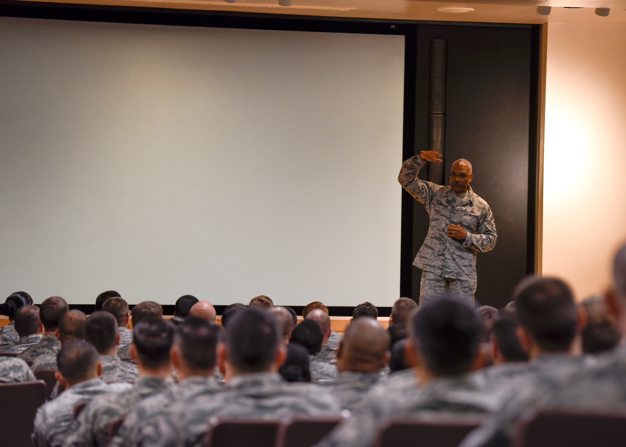 CMSgt. Jack Johnson gives a speech in front of a room filled with future NCOs.