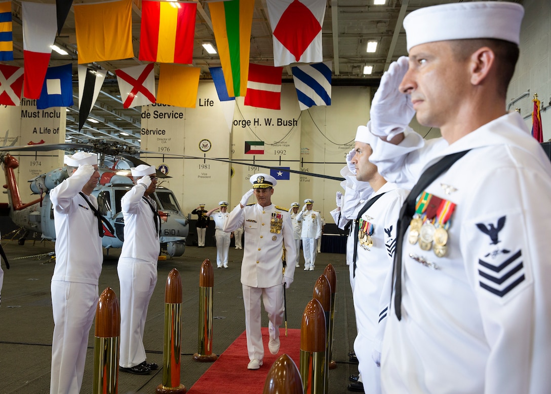 Navy Vice Adm. Andrew Lewis salutes as he arrives to the U.S. 2nd Fleet establishment ceremony aboard the nuclear aircraft carrier USS George H.W. Bush in Norfolk, Va.
