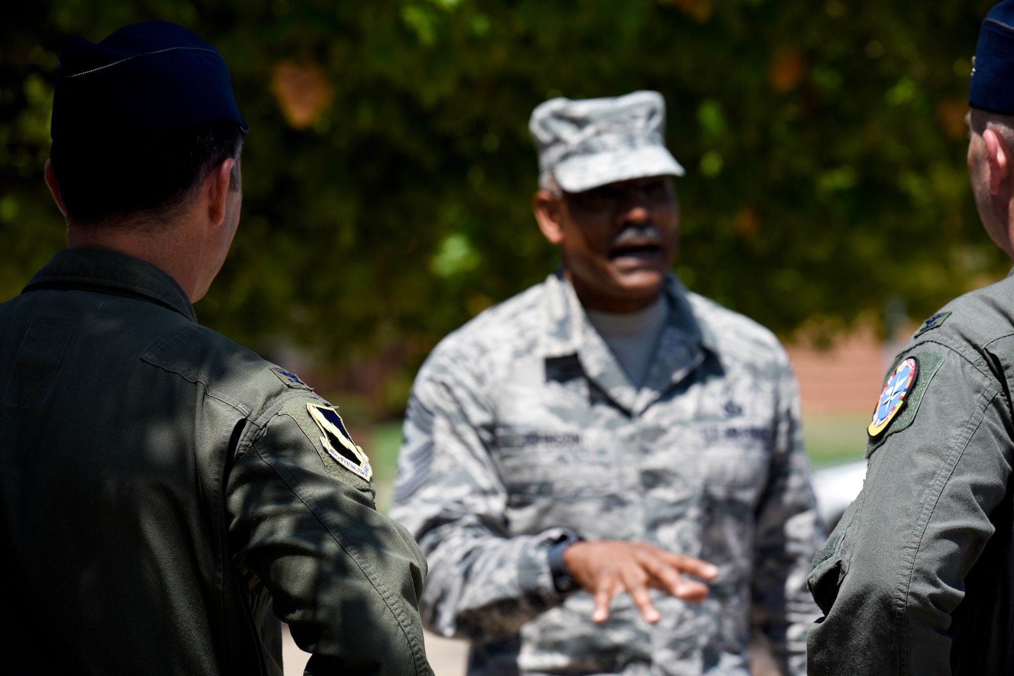 The two Colonels listen intently to CMSgt. Jack Johnson Jr. as he talks passionately about NATO.