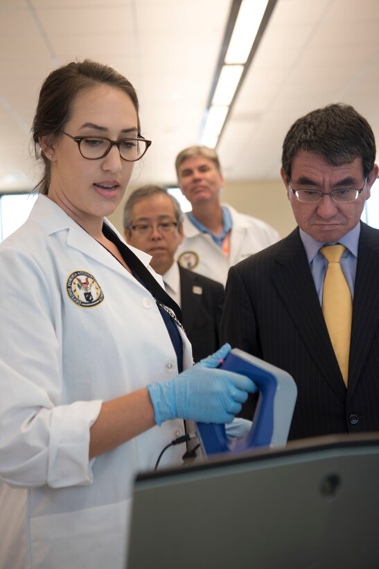 Taro Kono, Foreign Minister of Japan, right, is briefed by a forensic anthropologist with the Defense POW/MIA Accounting Agency (DPAA) during a tour at Joint Base Pearl Harbor-Hickam, Hawaii, Aug. 22, 2018. Kono and other delegates visited the agency’s facility for an orientation briefing of the identification processes of unknown U.S. service members. The mission of DPAA is to provide the fullest possible accounting for our missing personnel to their families and the nation. (U.S. Air Force photo by Tech. Sgt. Kathrine Dodd)