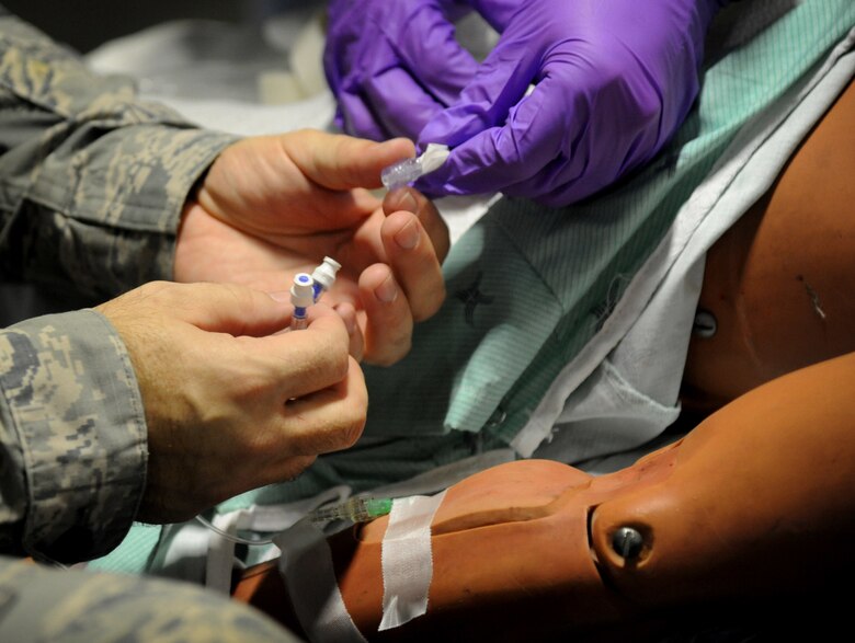 U.S. Air Force Capt. Rodney McIntyre, 927th Aeromedical Staging Squadron medical technician, administers an intravenous fluid into a patient due to dehydration during exercise Patriot Warrior on Aug. 17, 2018 at Fort McCoy, Wisc. The IV fluid ensures that the patient will be hydrated once again. Patriot Warrior is an exercise to ensure that Reserve Citizen Airmen and their counterparts from other services are mission-ready. Joint integration provides each service with the opportunity to learn from each other and develop rapport with their counterparts. (U.S. Air Force photo by Staff Sgt. Xavier Lockley)