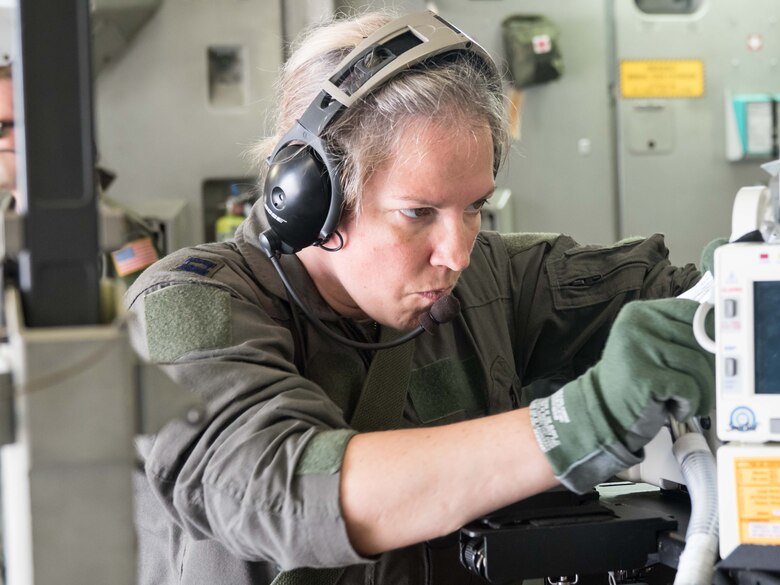 Capt. Tiffany Prochaska, 81st Medical Group, Keesler Air Force Base, Miss., makes some final adjustments to the life support equipment used by the Critical Care Air Transport Teams or CCATT, during Patriot Warrior 2018 at Minneapolis-St. Paul Air Reserve Station, Minn.Airmen from Reserve units across the country as well as those from the Polish Air Force are participated in Exercise Patriot Warrior Aug. 13-24. Aeromedical Evacuation Squadron Airmen and Critical Care Air Transport Teams worked from their operational headquarters at the 934th Airlift Wing during the exercise where they flew missions on C-130 and C-17 Aircraft. Patriot Warrior is an exercise to ensure that Reserve Citizen Airmen and their counterparts from other services are mission-ready. (Air Force Photo/Paul Zadach)