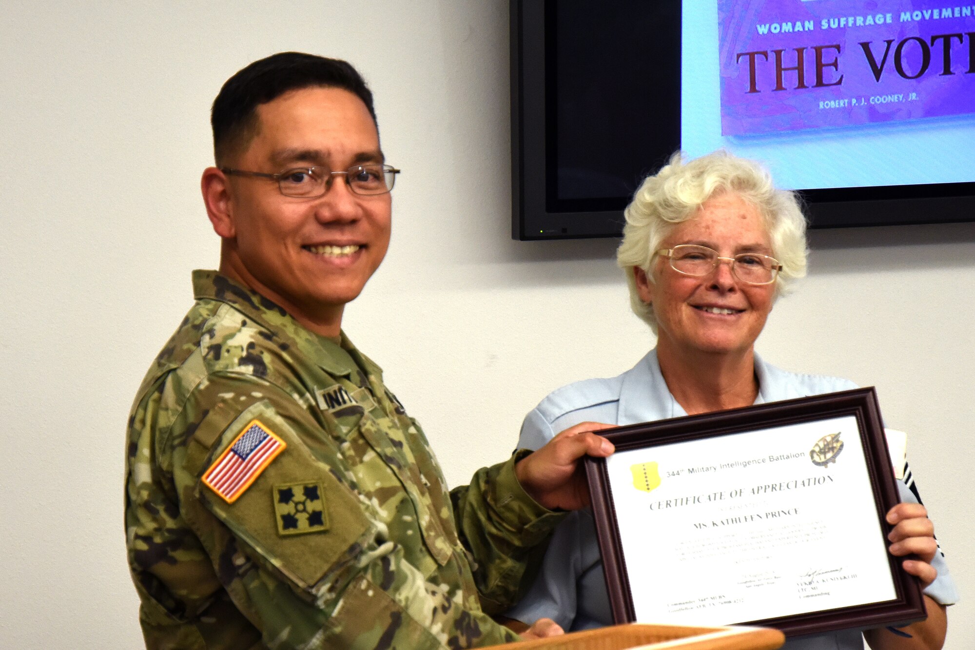 U.S. Army Lt. Col. Yukio Kuniyuki, 344th Military Intelligence Battalion commander, presents retired Chief Master Sgt. Kathleen Prince with a certificate of appreciation for speaking during the Women’s Equality Day event at Taylor Chapel on Goodfellow Air Force Base, Texas, Aug. 24, 2018. The 344th MI BN hosted the event in honor of Women’s Equality Day held annually to celebrate the signing of the Nineteenth Amendment allowing American women the right to vote. (U.S. Air Force photo by Airman 1st Class Seraiah Hines/Released)
