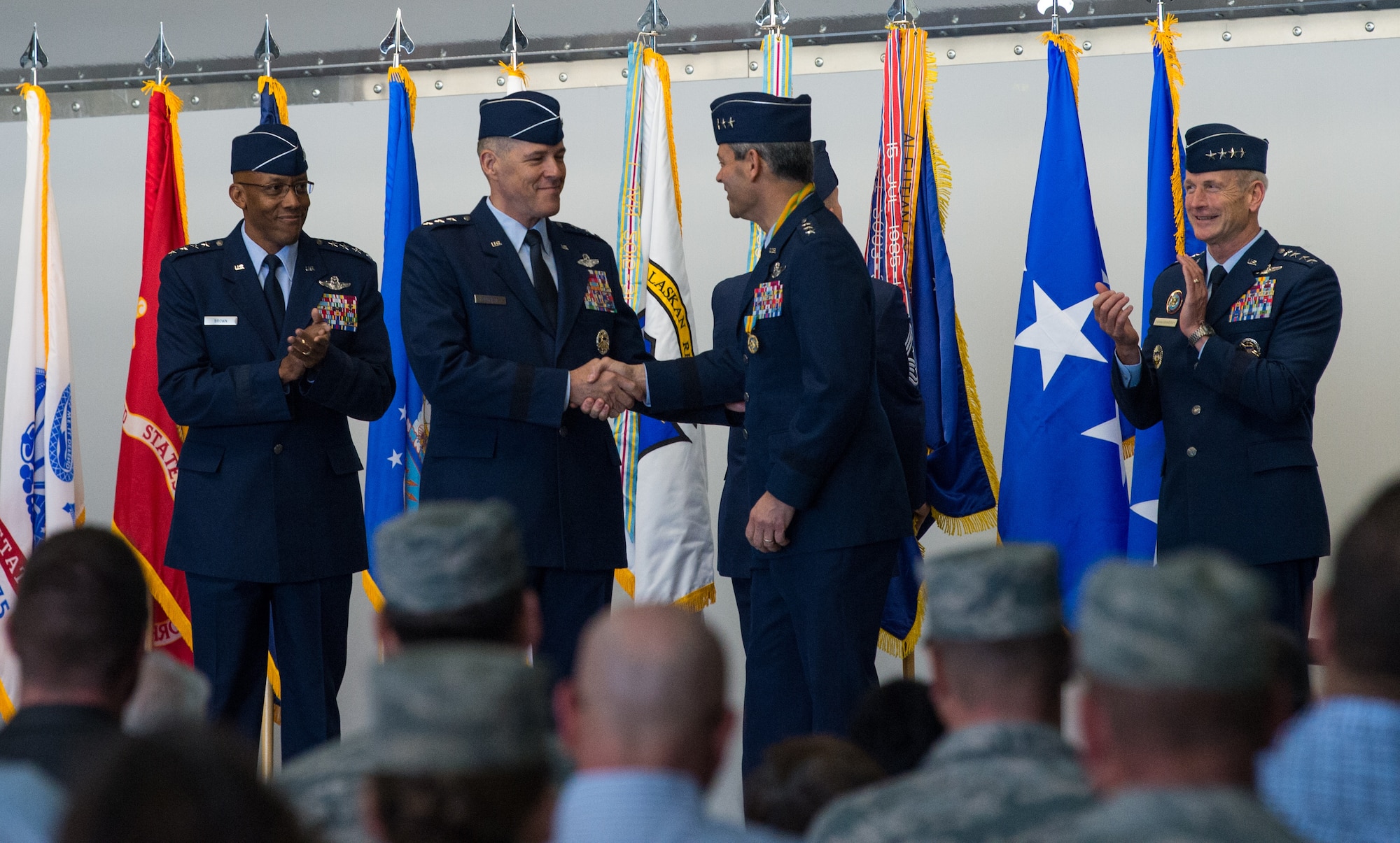 U.S. Air Force Lt. Gen. Tom Bussiere shakes hands with U.S. Air Force Lt. Gen. Ken Wilsbach, after a change of command ceremony in which Bussiere replaced Wilsbach as commander of Alaskan North American Aerospace Defense Command, Alaskan Command, and the Eleventh Air Force at Joint Base Elmendorf-Richardson, Alaska, Aug. 24, 2018. Family, friends, Arctic warriors and civic leaders from the surrounding communities attended the ceremony that was jointly-officiated by Air Force Gen. Terrence J. O’Shaughnessy, commander of the United States Northern Command and North American Aerospace Defense Command, and Gen. Charles Q. Brown, the commander of Pacific Air Forces.