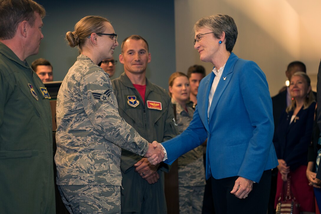 Secretary of the Air Force Heather Wilson coins an Airman of the 56th Fighter Wing, Aug. 24, 2018, at Luke Air Force Base, Ariz. During her visit to the base, Wilson met with and coined numerous Airmen from various units for their work and accomplishments. (U.S. Air Force photo by Senior Airman Ridge Shan)