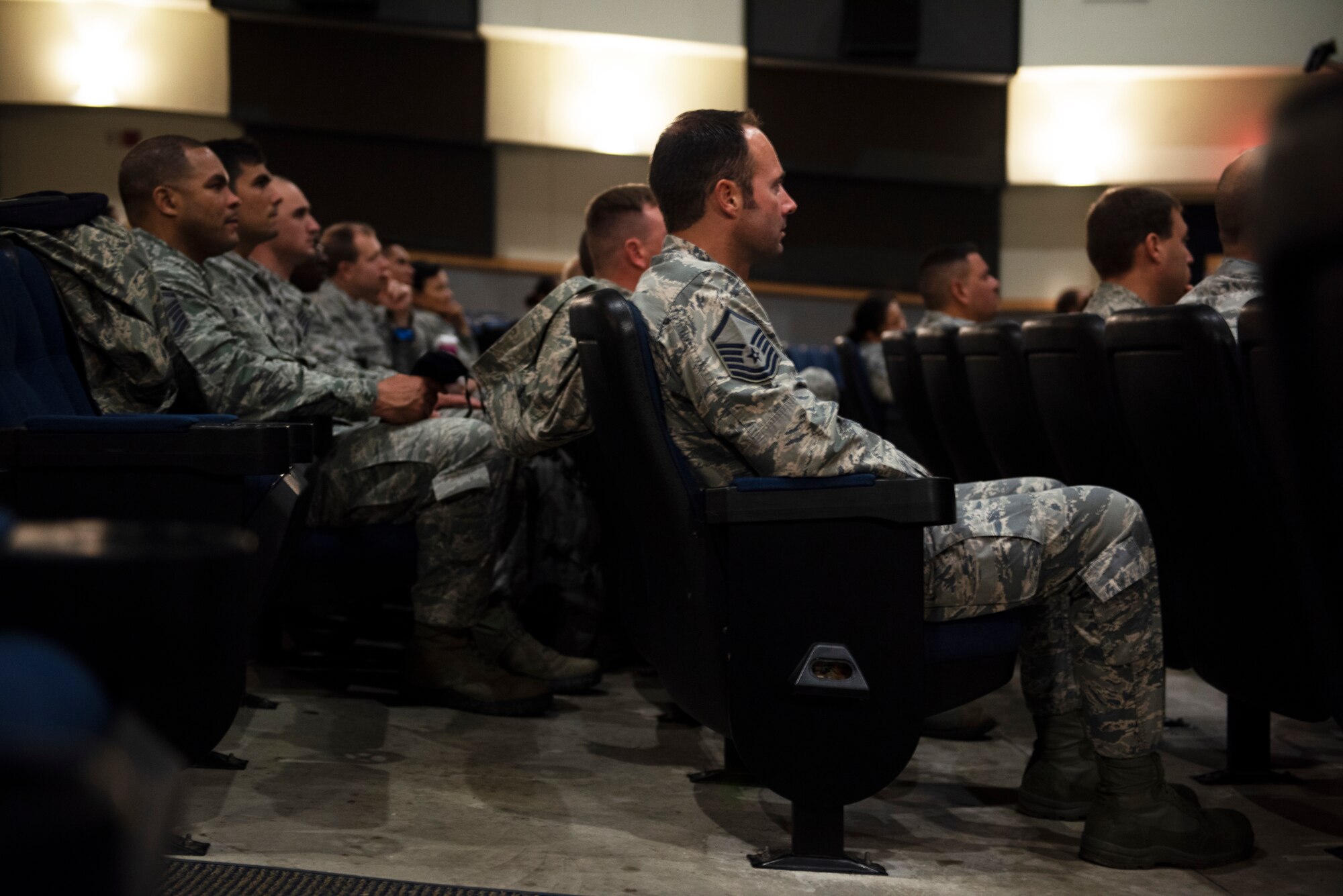 Members of the 8th Fighter Wing watch the Air Force Memorial name unveiling ceremony for Master Sgt. John Chapman held in Arlington, VA, at Kunsan Air Base, Republic of Korea, Aug. 27, 2018. Chapman was a combat controller from the 24th Special Tactics Squadron who was killed in action on March 4, 2002 during the battle of Takur Ghar, otherwise known as Robert’s Ridge. Chapman charged into heavy enemy fire to rescue a team of special operators that was ambushed by enemy fighters.