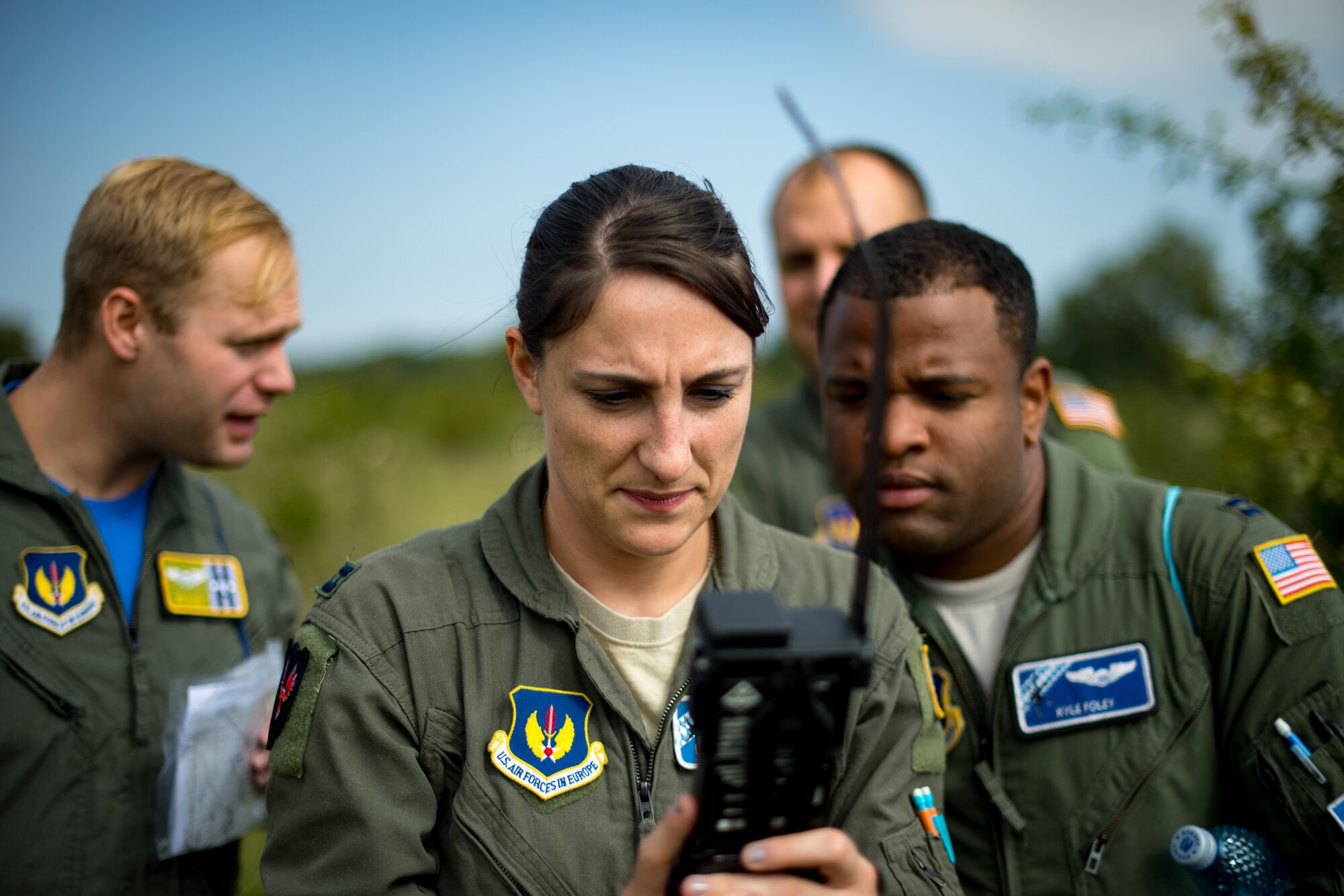 U.S. Air Force Capt. Jane Marlow, 37th Airlift Squadron pilot, configures a radio during a Survival, Evasion, Rescue, and Escape scenario in Bolovani, Romania, Aug. 24, 2018.