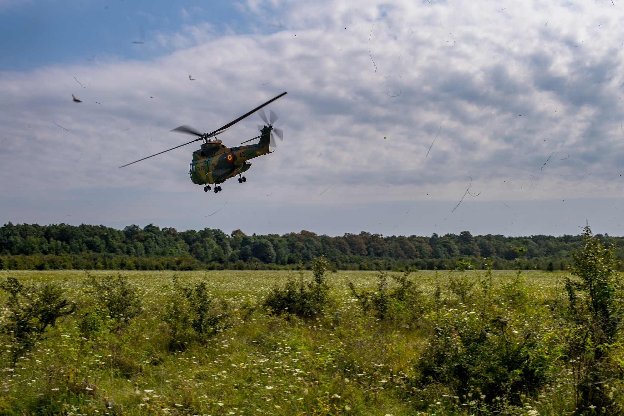 A Romanian air force IAR-330 Puma helicopter takes off after simulating a rescue mission with U.S. Air Force 37th Airlift Squadron pilots during a Survival, Evasion, Rescue, and Escape scenario in Bolovani, Romania, Aug. 24, 2018.