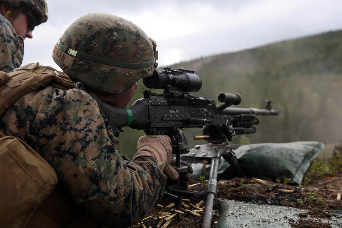 A U.S. Marine with Marine Rotational Force-Europe 18.1 fires an M240B machine gun during a live-fire range at Giskas, Norway.