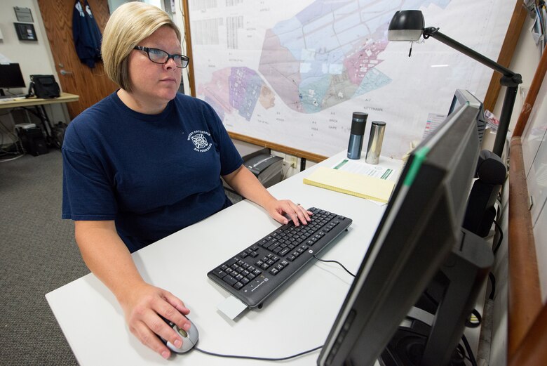 Stephanie Nevin, Wright-Patterson Air Force Base Fire Department emergency vehicle dispatcher, works on GeoBase, a detailed online map that uses a graphical user interface and overlays to allow first responders to see detailed information all around the base August 27, 2018.