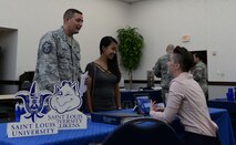 Master Sgt. Scott Baker, 18th Air Force, talks to a representative from Saint Louis University at the Education Fair on Aug. 16, 2018 at the Scott Air Force Base Events Center on Scott AFB, Ill. Representatives from over 40 Colleges, universities, and education support agencies attended the fair to give participants an opportunity to compare educational opportunities.