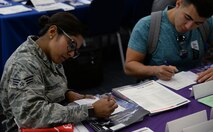 Senior Airman Aisha Rodriguez, 932nd Logistics Readiness Flight, fills out a contact sheet provided by one of the booths at the Education Fair, Aug. 16, 2018 at the Scott Air Force Base on Scott AFB, Ill. The 375th Force Support Squadron held an education fair to give service members an opportunity to compare degree programs, admissions requirements, delivery formats, student services, and costs to select a program that best meets their unique circumstances.