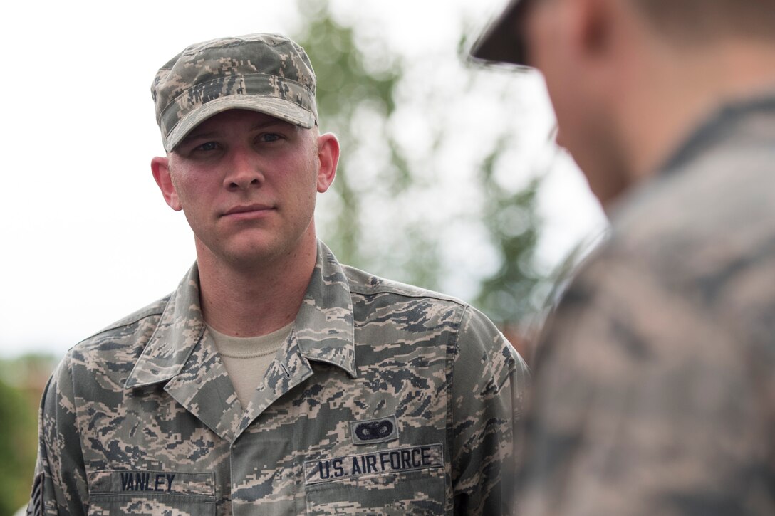 U.S. Air Force Staff Sgt. Aaron Vanley, 633rd Security Forces Squadron base defense operations center controller, speaks tactics with fellow Air Combat Command security forces members during the Defender Challenge team selection at Joint Base Langley-Eustis, Virginia, Aug. 20, 2018.