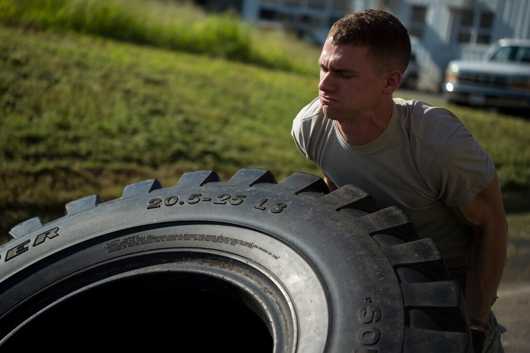 U.S. Air Force Staff Sgt. Anthony Zygmunt, 7th Reconnaissance Squadron alarm monitor, flips a tire during a physical training test as part of Air Combat Command’s Defender Challenge team selection at Joint Base Langley-Eustis, Virginia, Aug. 24, 2018.