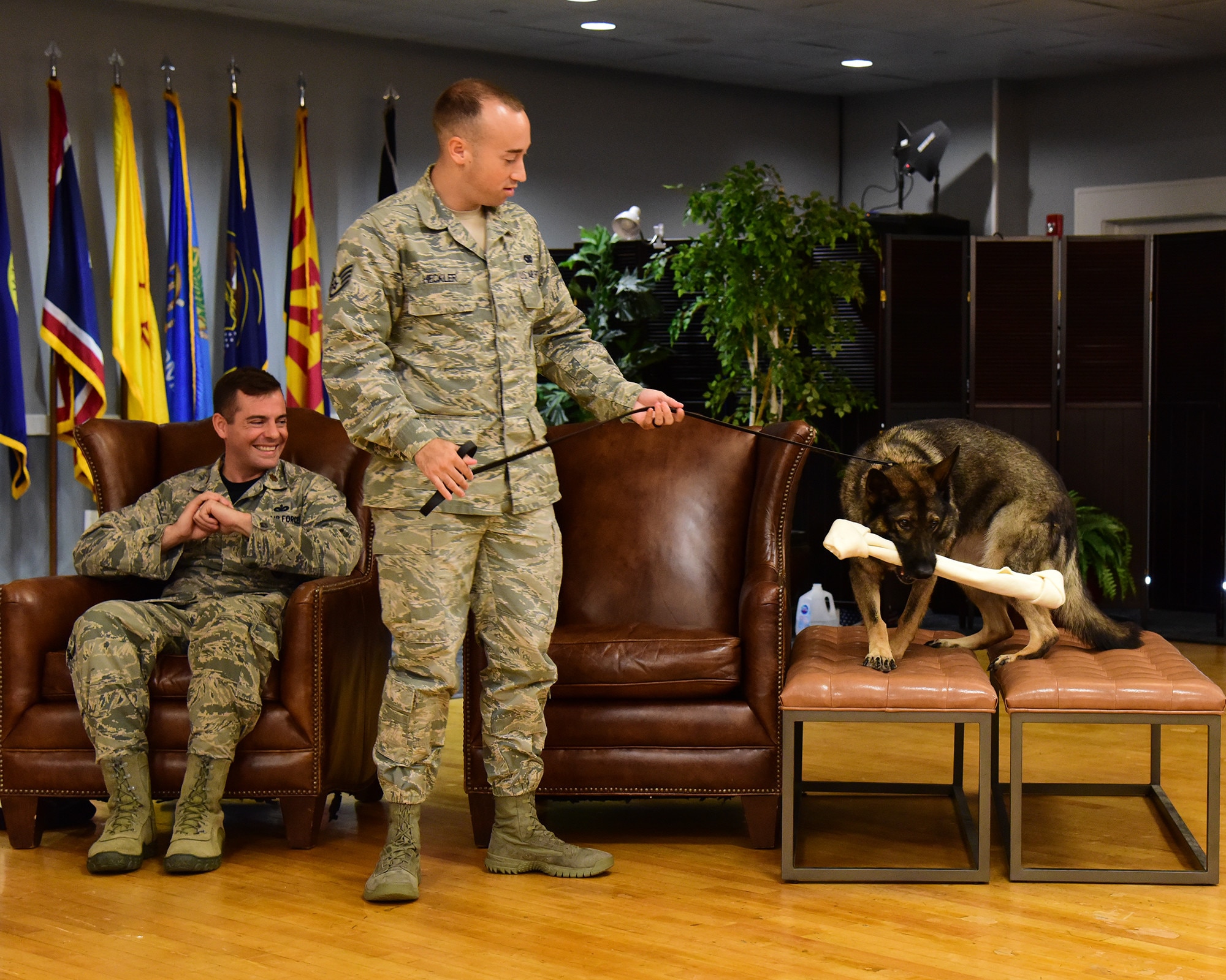 Staff Sgt. Nicholas Heckler, former 14th Security Forces Squadron military working dog handler, prepares to walk with newly retired MWD Cherry, during her retirement ceremony Aug. 24, 2018, on Columbus Air Force Base, Mississippi. Cherry retired after serving the Air Force for 10 years, and will go on to live with Heckler. (U.S. Air Force photo by Elizabeth Owens)
