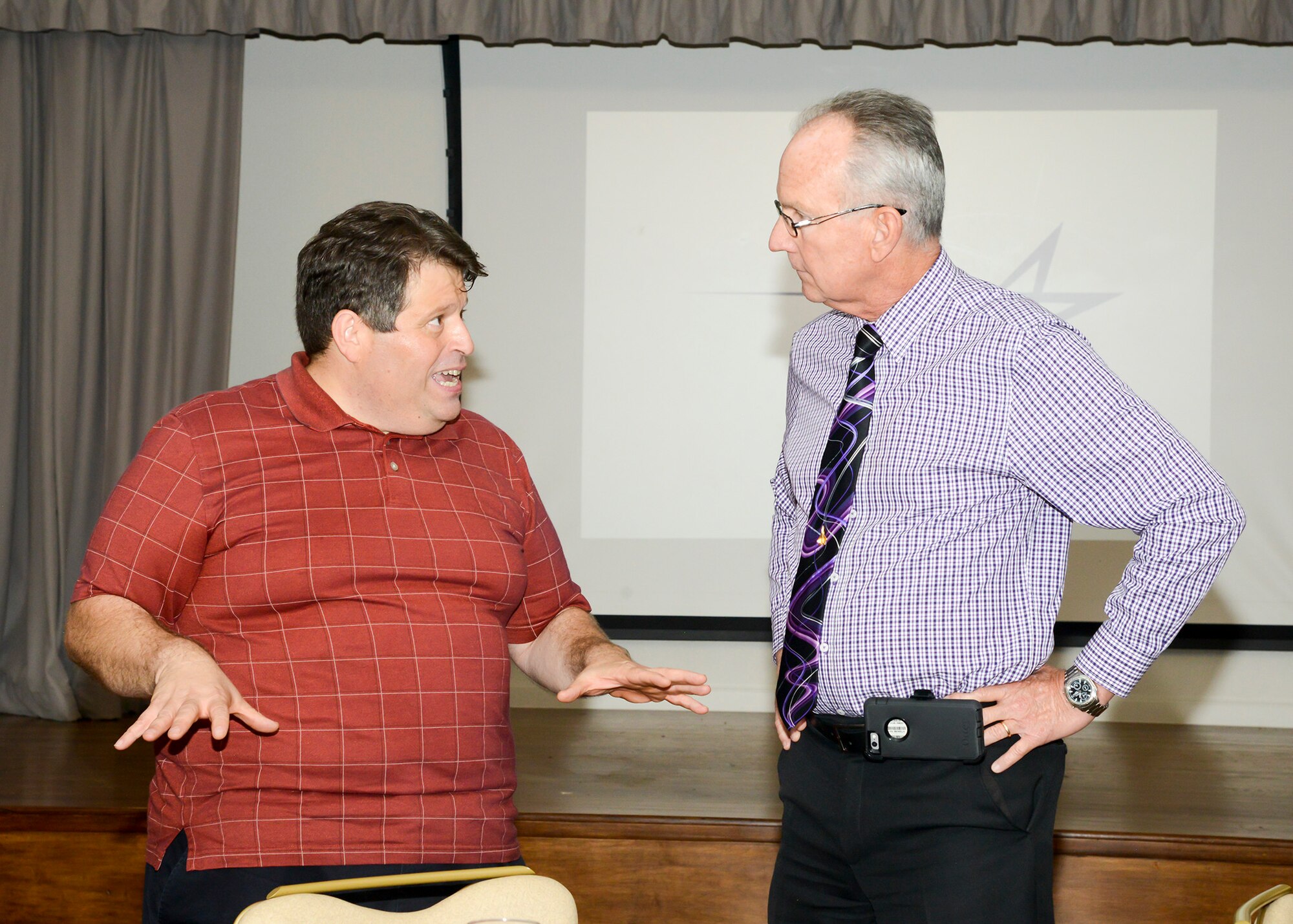 Keynote speaker Patrick Lardier, a technical fellow for cyber technology and operations, talks with Dr. David Smith, Edwards Air Force Base Installation Support director, during the International Test and Evaluation Antelope Valley Chapter’s quarterly luncheon at Edwards Air Force Base, Aug. 23. (U.S. Air Force photo by Giancarlo Casem)