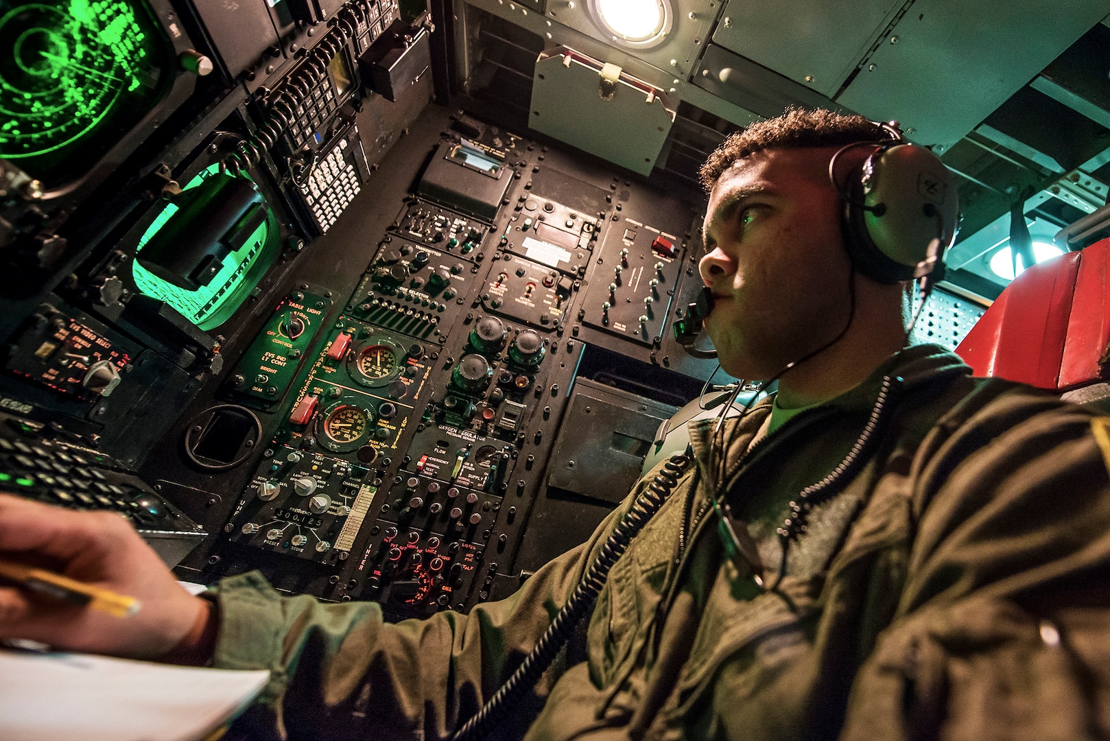 Air Force 1st Lt. Nathan Fisher, 23rd Bomb Squadron weapons system officer, analyzes an offensive avionics system inside a B-52H Stratofortress above North Dakota. Fisher sits in the offense compartment of the aircraft, controlling the B-52’s weapons capabilities.