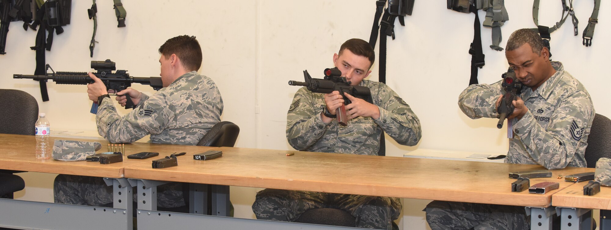 Airmen check their sites during M4 rifle qualifying course