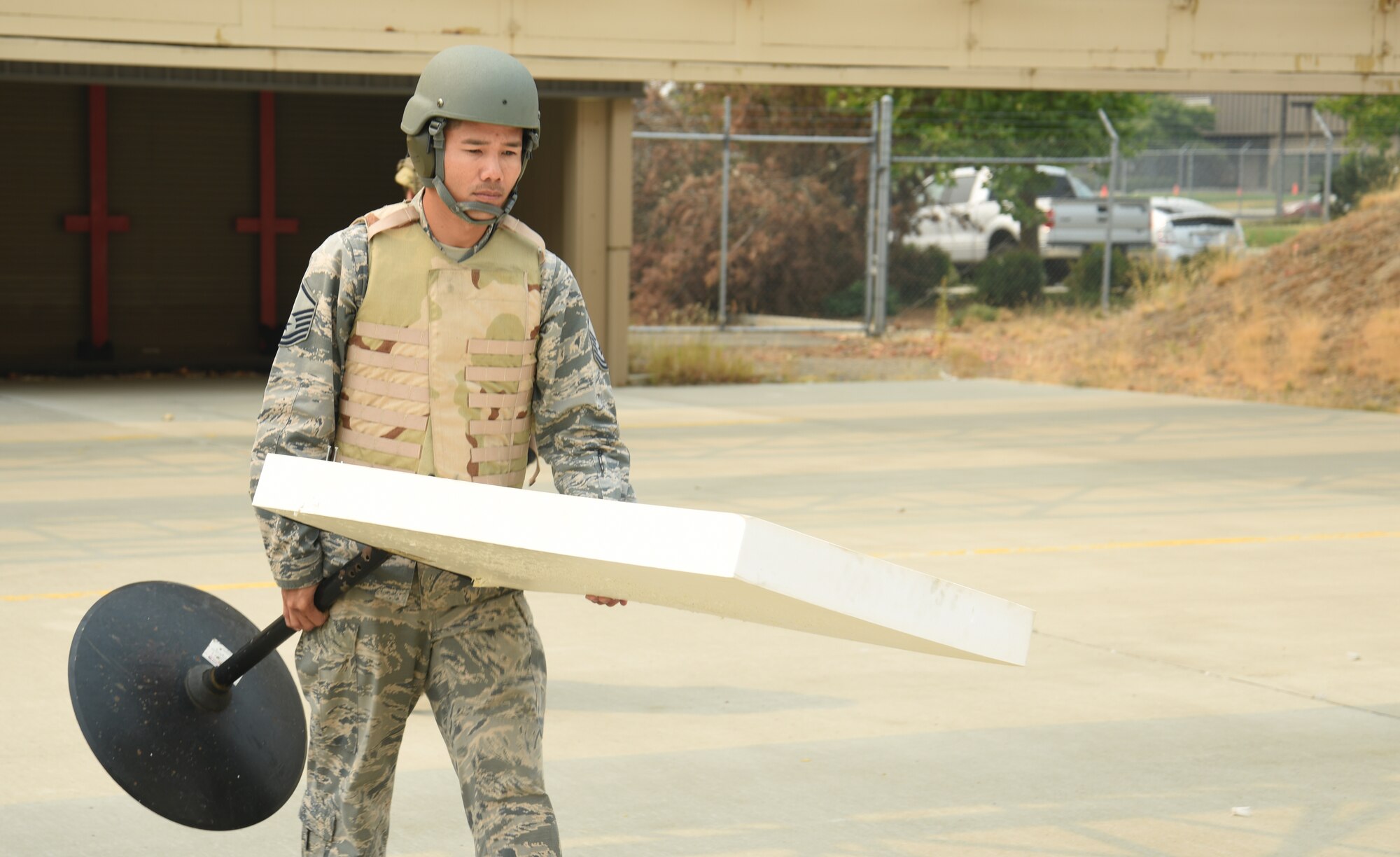 Force Master Sgt. Samnang carries his target onto the Combat Arms course.