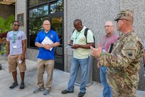 Several participants receive a briefing while walking through Detroit during the 2018 DoD Support of Civil Authorities (DSCA)/Chemical, Biological, Radiological and Nuclear (CBRN) Dense Urban Terrain Training Tactical Exercise Without Troops exercise on Aug. 23. The particpants were among some of the 150 participants from more than 50 organizations of the interagency, to include local, state, federal and international partners. The attendees studied the layout of the city and discussed the challenges of conducting urban search and rescue and other DSCA rescue efforts in a city such as Detroit, which ranks third in the state for population density. The training was held by the 46th Military Police Command, Michigan Army National Guard, Command and Control CBRN Response Element – Bravo and included other key training stops within the city landscape. Members of Joint Task Force Civil Support also participated in the exercise. (Official DoD photo by Mass Communication Specialist 3rd Class Michael Redd/released)