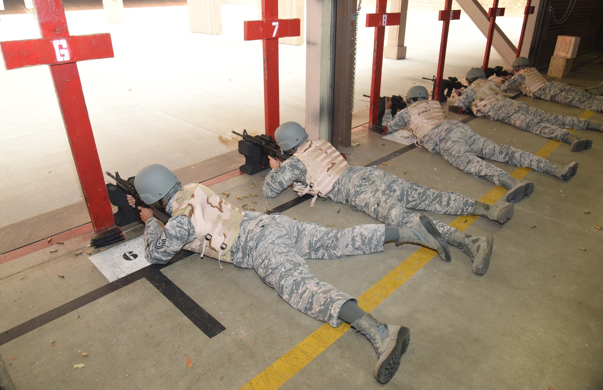 Airmen lay in prone support position during an M4 rifle qualifying course
